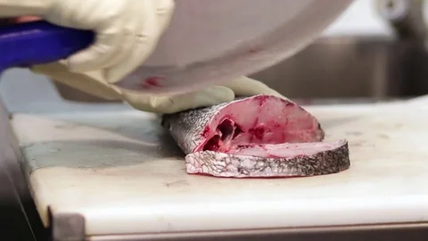 Fishmonger cutting fish Stock Footage 75451635