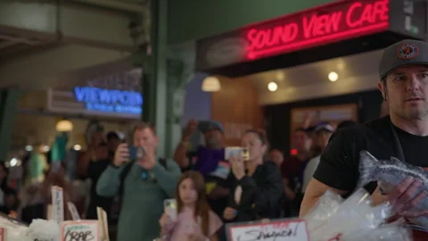 Fishmonger Grabs Salmon and Exits Frame Inside Pike Place Market Stock Footage 341338173