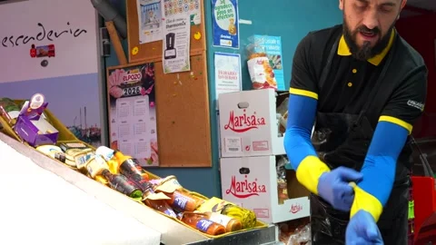 Fishmonger putting on disposable gloves for work Stock Footage 336358780