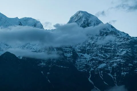 Fishtail Machapuchare summit with clouds passing by, Nepal Stock Photos