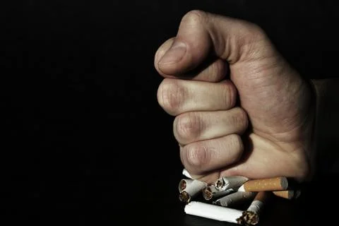 Fist on cigarettes Stock Photos