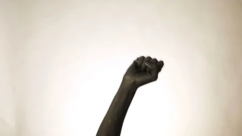Fist gesture on a dark background. Black hand doing Fist symbol. Hands up protes Stock Footage 100681423