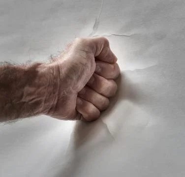Fist hits wall 스톡 사진