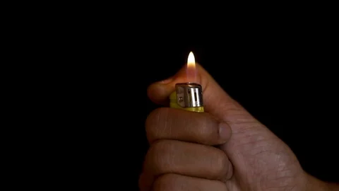 Fist lighting a cigarette lighter, in slow motion. Stock Footage 120944841