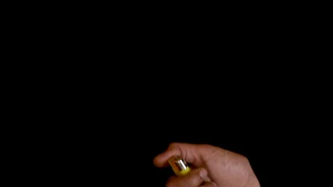 Fist lighting a cigarette lighter, in slow motion. Stock Footage 120945679
