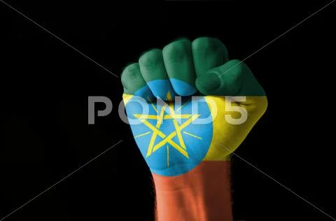 Fist painted in colors of ethiopia flag Stock Photos
