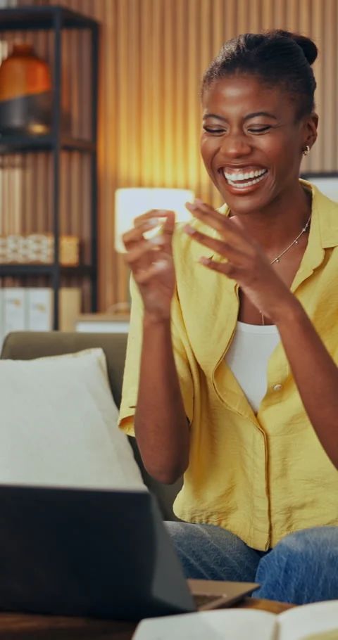 Fist pump, laptop and black woman in home on sofa with remote work for creative Stock Footage 337459395