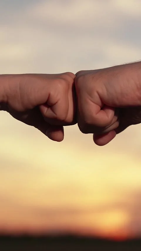 Fists express agreement, respect gesture. Male female fists against sky Stock Footage 299737799