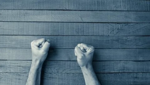Fists on a wooden table Foto stock