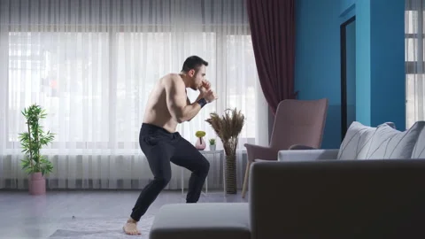 Fit and handsome boxer doing shadow boxing in the gym. Video stock 232277104