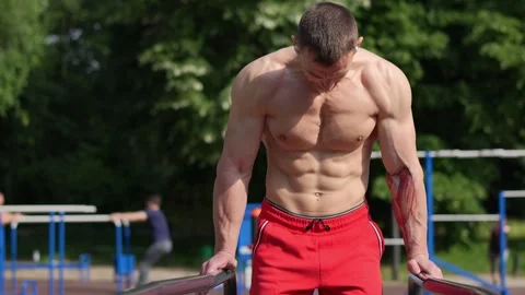 Fit athlete exercising on pull up bars Stock Footage 244373251