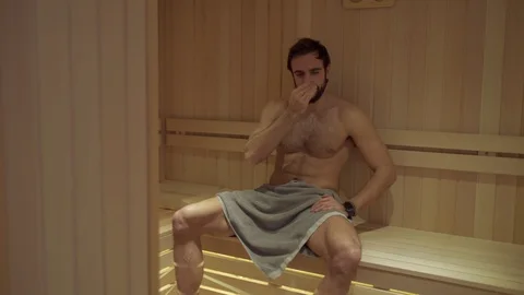 Fit bearded man sweating in the spa sauna Stock Footage 127649016
