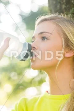 Fit blonde drinking from water bottle Stock Photos