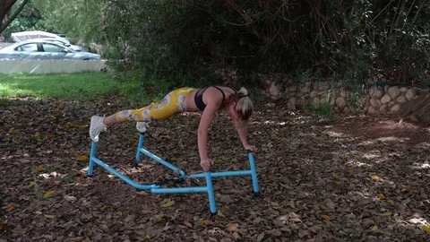Fit blonde workout with parallel bars Stock Footage 115933484