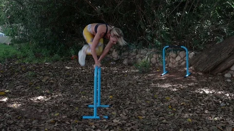 Fit blonde workout with parallel bars Stock Footage 115934659