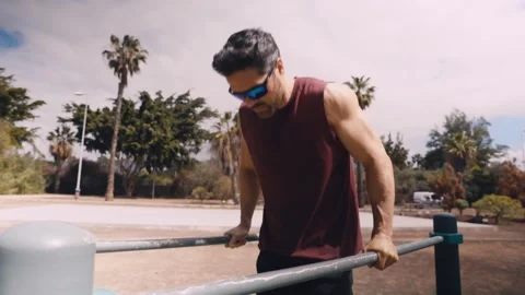 Fit Caucasian Man Doing Dips on Parallel Bars at Tropical Outdoor Gym Video stock 308758996
