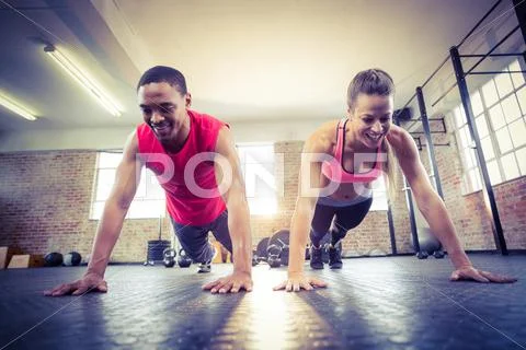 Fit couple doing push ups Stock Photos