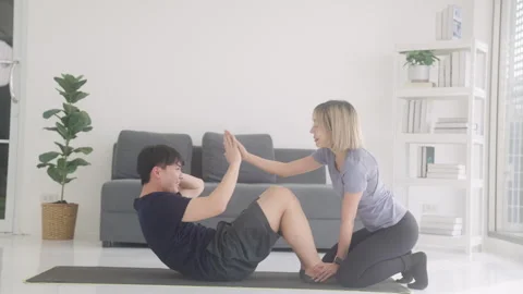 Fit couple having fun exercising at home Stock Footage 248591588