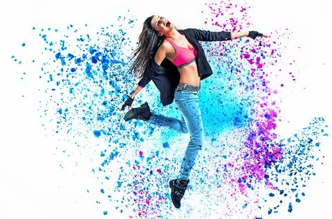 Fit dancer jumping into the paint splash Stock Photos
