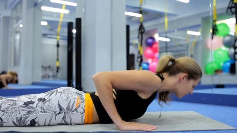 Fit girl is doing  exercises for the back Stock Footage 105344971