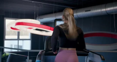 Fit girl running on a treadmill Stock Footage