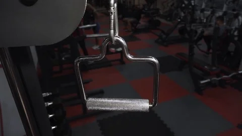 Fit guy grubs shiny handle of gym machine Video stock 117909622