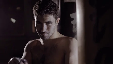 Fit handsome smiling man gets hand to boxing position. 库存影片 76917262