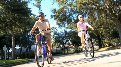 Fit & Healthy Retired Couple Cycling Together Stock Footage