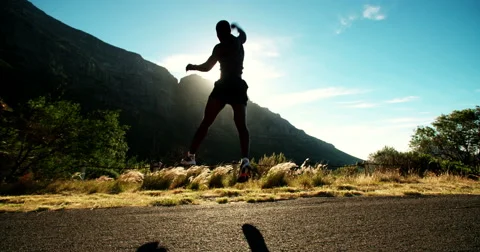 Fit joyful athlete leaping into the air in triumph slow motion Stock Footage
