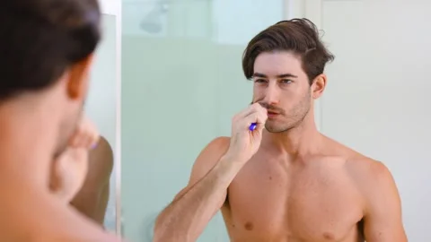 Fit man brushing his teeth 動画素材 294999344