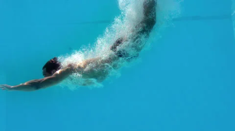 Fit man diving underwater in swimming pool Stock Footage