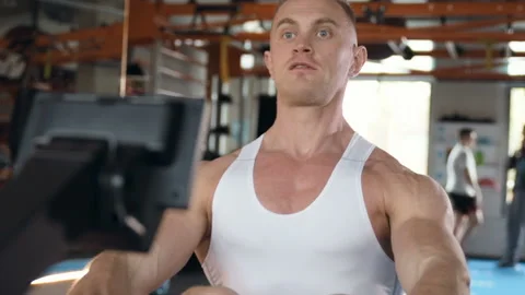 Fit man doing bent-over rows in the gym at workout. Video stock 149982983