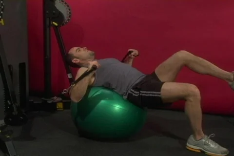 Fit man doing a chest exercise on a stability ball Stock Footage 268523