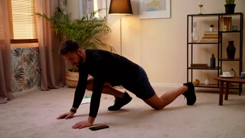 Fit Man Doing Mountain Climber Exercises While Using A Stopwatch On His Phone Stock Footage 145244517