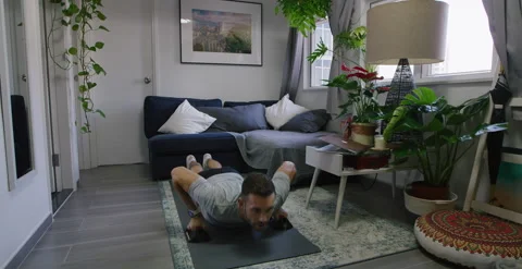 Fit Man Doing Push-Ups In His Living Room, 6K Stock Footage 147176371