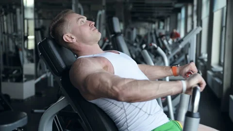 Fit man doing push ups at machines in the gym. Video stock 149983709