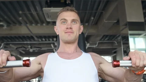 Fit man doing push ups at machines in the gym. Video stock 149983732