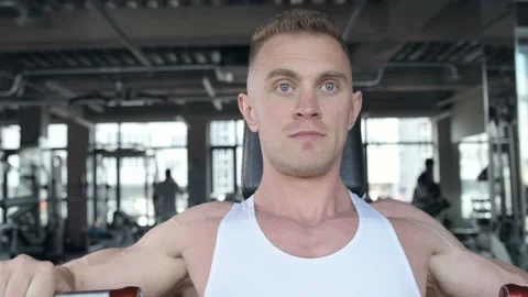 Fit man doing push ups at machines in the gym. Stock Footage 149983748