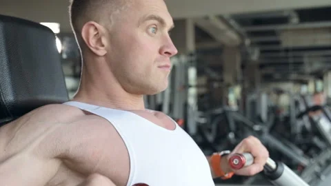 Fit man doing push ups at machines in the gym. Video stock 149983829