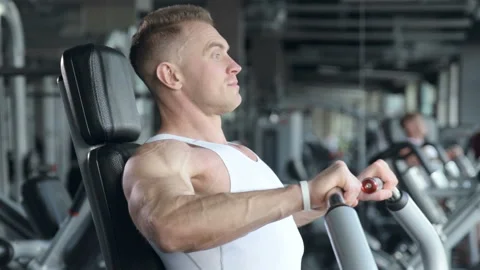Fit man doing push ups at machines in the gym. Video stock 149983882