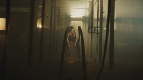 Fit man doing rope workout Stock Footage 236184588