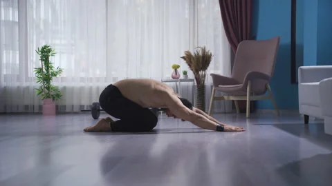 Fit man doing stretch called child pose at home. Exercise moves. Stock Footage 232280074