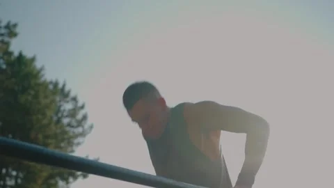 Fit Man Exercising Outdoors on Parallel Bars at Sunrise for Strength Training Stock-Footage 313049225