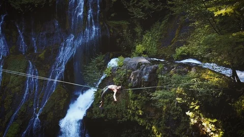 Fit Man Highlining Over A Waterfall Video stock 111580450