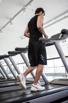 Fit man jogging on the treadmill Stock Photos