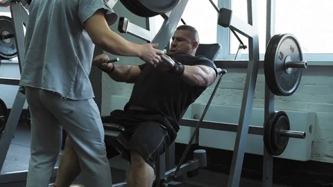 Fit man lifting dumbbell at gym Stock Footage 69941453