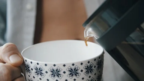 Fit man in opened button down shirt pouring coffee Stock Footage 97737033