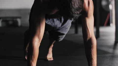 Fit man performs push ups in gym focusing on strength and endurance training Stock Footage 312762565