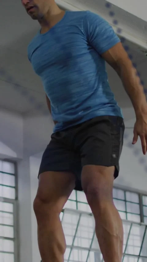 Fit man preparing at plyo box, driving legs and jumping onto box, landing for Stock Footage 331029800