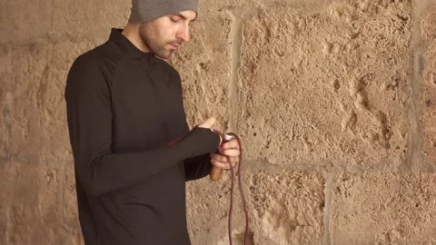 Fit man preparing for workout with jumping rope outdoors Stock Footage 132053509